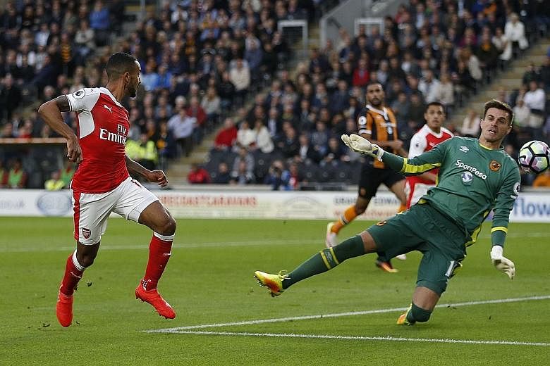 Theo Walcott scoring Arsenal's second goal at Hull. The Gunners comfortably defeated 10-man Hull despite Alexis Sanchez missing a penalty. Arsenal won a third consecutive Premier League game for the first time this year.