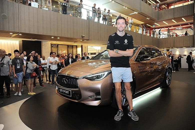 Renault's Jolyon Palmer with the newly launched Infiniti Q30 at a roadshow at Paragon. Having driven and now raced at the highest level, the Briton aims to one day mount the podium, win a race or even the title.