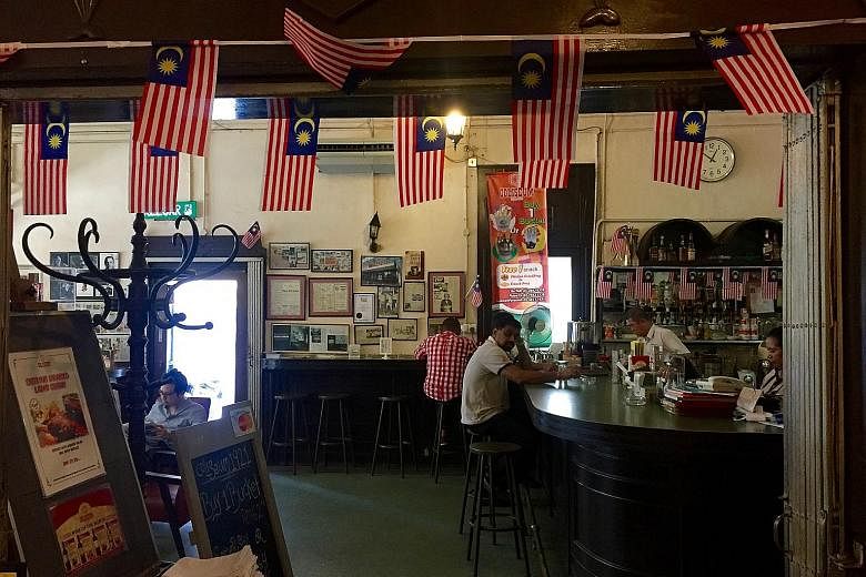 The bar at the original Coliseum outlet retains an old-world charm.