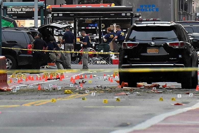 Emergency workers at the scene of the explosion in New York City on Saturday night. New York Governor Andrew Cuomo has called the powerful explosion that injured 29 people "an act of terrorism", but said no link to international groups had been found