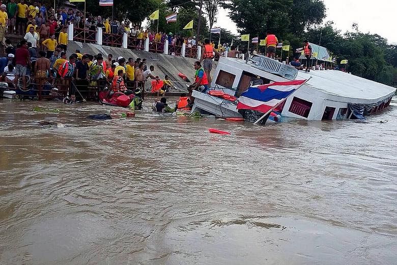 Rescuers helping survivors after a boat accident yesterday on the Chao Phraya River in Ayutthaya. The ferry had been carrying 150 Muslim Thai passengers who were returning from a religious trip. At least 12 people were killed and dozens injured. Sear