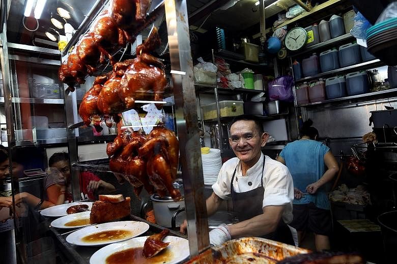 Liao Fan Hong Kong Soya Sauce Chicken Rice & Noodle stall owner Chan Hon Meng (left) sells about 160 chickens daily.