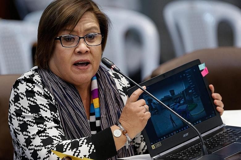 Ms de Lima showing an image of a crime scene at the hearing on killings of drug suspects in the Philippine Senate last week. Yesterday, she was accused of trying to destroy President Rodrigo Duterte.