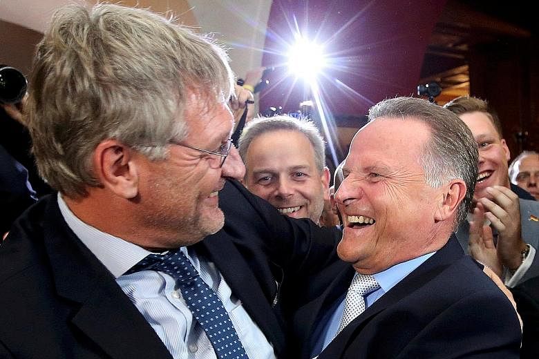 AfD's co-leader Joerg Meuthen (left) and the party's top Berlin candidate, Mr Georg Pazderski, smiling after the first exit polls of the Berlin election in Germany on Sunday. The anti-Islam party won fresh support.