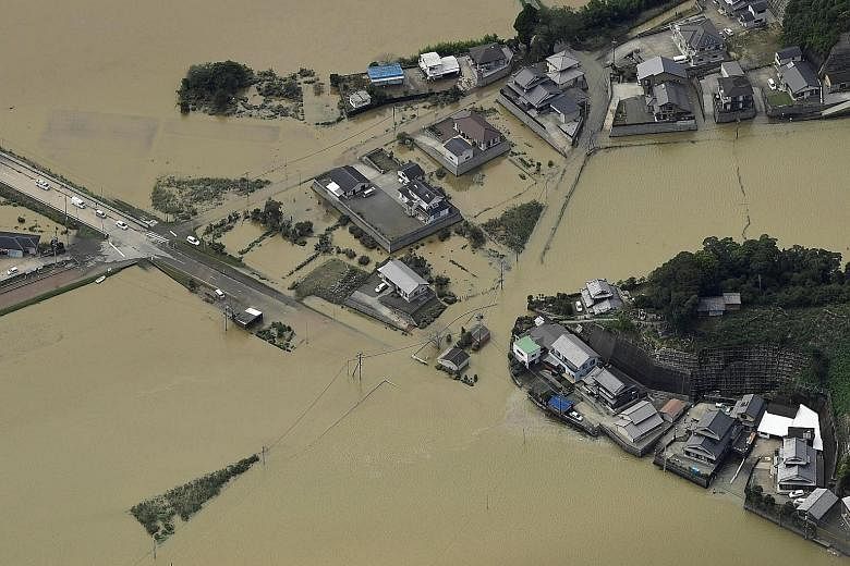 An aerial view of the damage from floods due to heavy rain brought by Typhoon Malakas in the south-western city of Nobeoka in Japan's Miyazaki prefecture yesterday. At least 36 people were injured and one went missing as the powerful typhoon, packing