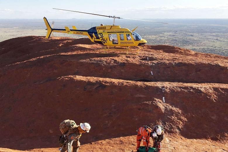 Rescuers at the top of Uluru preparing for the complex process of extracting three young men stuck in a crevasse. The rescue operation took 16 hours. 