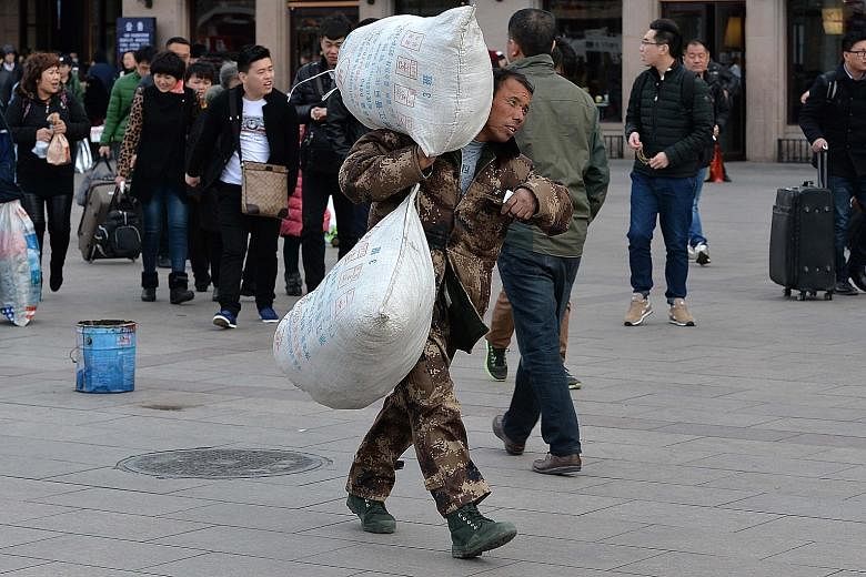 A migrant worker at Beijing Railway Station. China aims to have 60 per cent of its population living in cities by 2020.