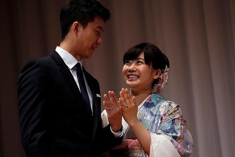 Japanese star Ai Fukuhara and husband Chiang Hung-chieh showing off their custom-made wedding rings, engraved with table tennis balls, at a news conference in Tokyo to announce their marriage. Chiang, her fellow Rio Olympian from Chinese Taipei, desi
