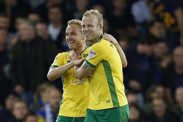Everton old boy Steven Naismith celebrates opening the scoring with Alex Pritchard (left). After Norwich's 2-0 win on Tuesday, Everton manager Ronald Koeman said: "We don't cry when we lose".
