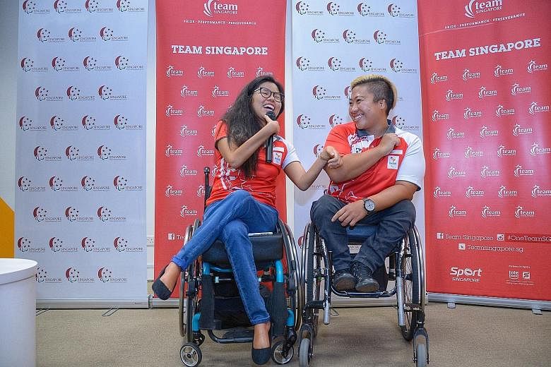Above: Rio Paralympics medallists Yip Pin Xiu (left) and Theresa Goh sharing a light moment at a press conference yesterday. Left: Paralympic double gold medallist Yip showing her medals to her nieces Shernice Ang, four, and Chew Xiu Wen, 10, after a