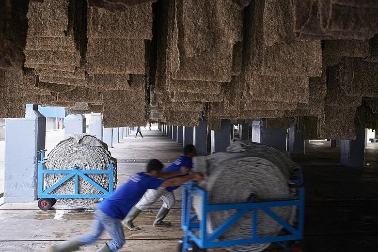 Natural rubber is formed into blankets as part of the process of making Standard Indonesian Rubber at a Halcyon Agri facility in Palembang, Indonesia.