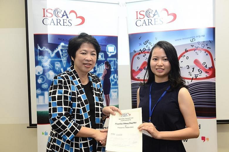 Ms Phung (right), a Singapore Polytechnic accountancy student, receiving her bursary from Mrs Lim, chairman of Isca Cares, on Tuesday.