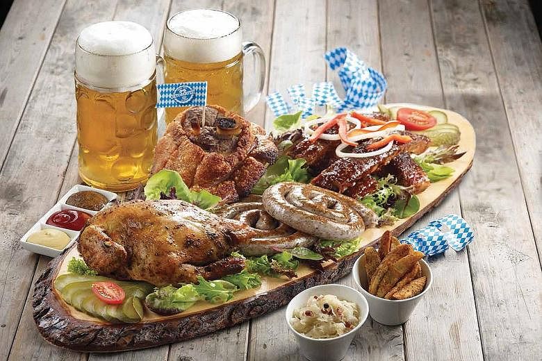 Brotzeit's Oktoberfest Platter includes beer-infused Bavarian honey ribs, oven- roasted pork knuckle, roast spring chicken, sausages, wedges and sauerkraut