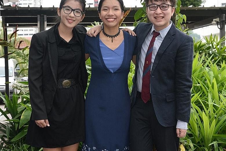 (From far left) Ms Teo Zi Lin, Ms Sarah Lim and Mr Joshua Ong received the Asia Pacific Breweries Foundation Scholarship for Persons with Disabilities yesterday at the Enabling Village in Lengkok Bahru. The awards were given in recognition of their s