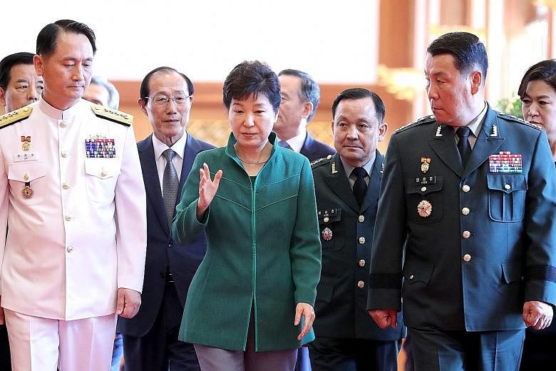 President Park with Vice- Admiral Um Hyun Seong (far left), the new Navy Chief of Staff, and Lieutenant General Lim Ho Young, the new deputy commander of the South Korea-US Combined Forces Command, after attending a ceremony in Seoul yesterday to mar