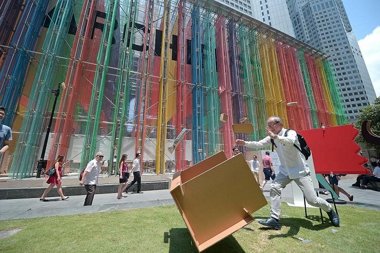A man de-stressing during lunchtime at the #FlipTable activity station at Raffles Place lawn yesterday, set up as part of this year's Archifest festival, which celebrates architecture and the built environment. The theme of this year's 10th anniversa
