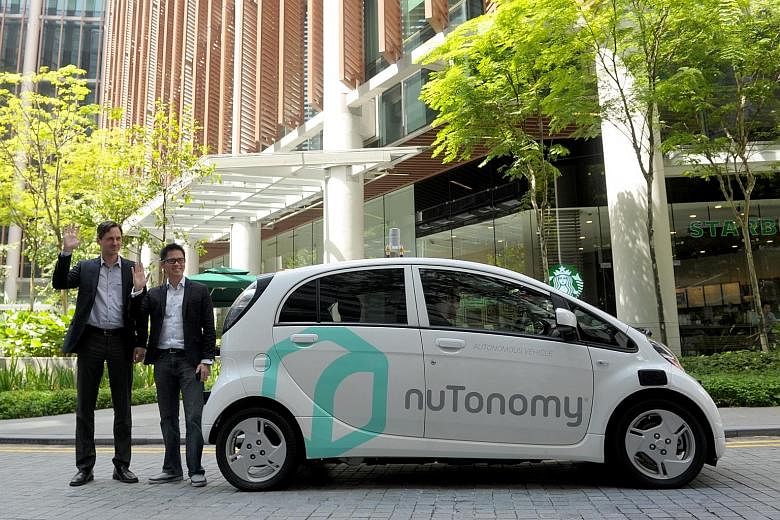 nuTonomy chief Karl Iagnemma (left) and Grab Singapore head Lim Kell Jay with a test car. nuTonomy has been testing the vehicles in the one-north area since April and has tied up with ride-hailing service Grab to let a select group of its customers t