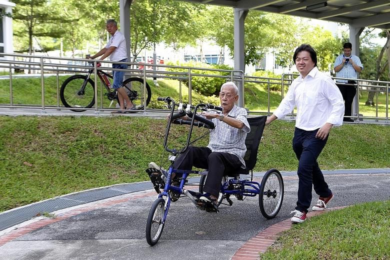 Businessman Axl Loon (above right), whose company is the marketing agent for the MonoMano Tricycle, with Mr Chua Keng Kok on the tricycle.