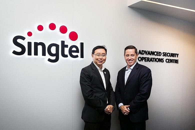 Singtel's Mr Chang (left) and Palo Alto's Mr McLaughlin. Their firms have teamed up to provide the Advanced Threat Prevention service, which helps firms secure their networks, mobile phones and tablets, enabling employees to take their own devices to
