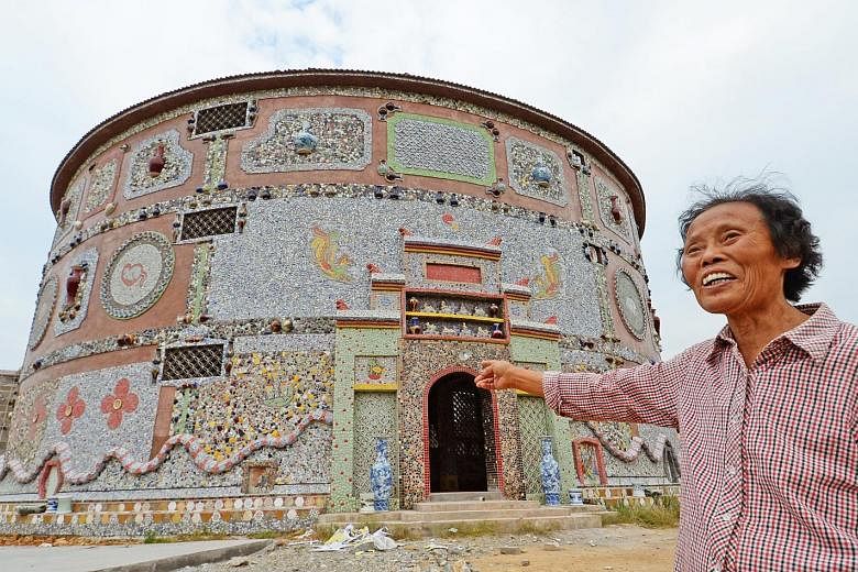 Ms Yu Ermei, 86, showing the way to her "porcelain palace", built at a cost of 6 million yuan (S$1.2 million). She started on the project five years ago. More than 60,000 pieces of porcelain ware were used to construct the building. Ms Yu runs a porc
