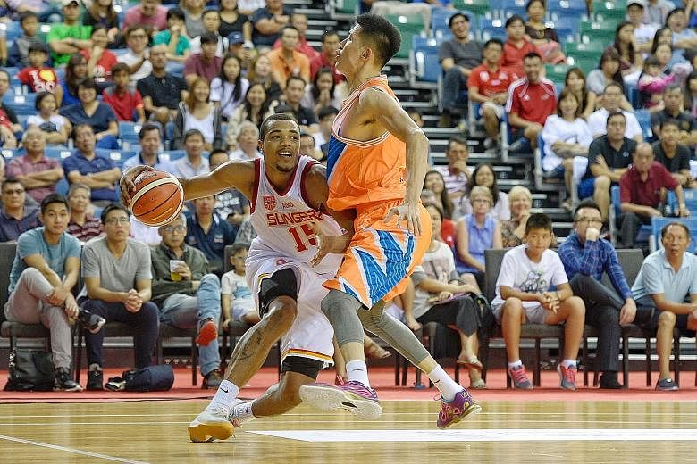 The Singapore Slingers' American import Xavier Alexander driving to the basket against Cai Liang of the Shanghai Sharks in their Merlion Cup Group A game last night. The Sharks, owned by former National Basketball Association star Yao Ming, overpower