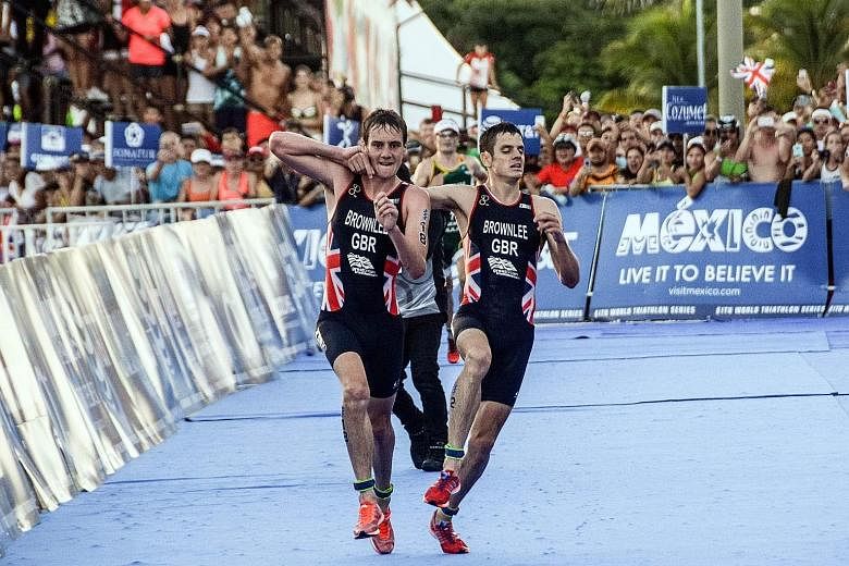 British athlete Alistair Brownlee (left) helping his younger brother Jonathan across the line during the World Triathlon Championships in Mexico on Sept 18. "It was a natural human reaction," the older sibling said after the race.