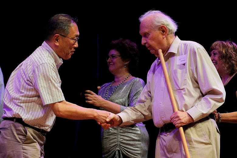 Theoretical physicist Roy Glauber (right), winner of the 2005 Nobel Prize in Physics, congratulating Mr Atsuki Higashiyama of Japan at the Ig Nobel Prize ceremony at Harvard University in Cambridge on Thursday.