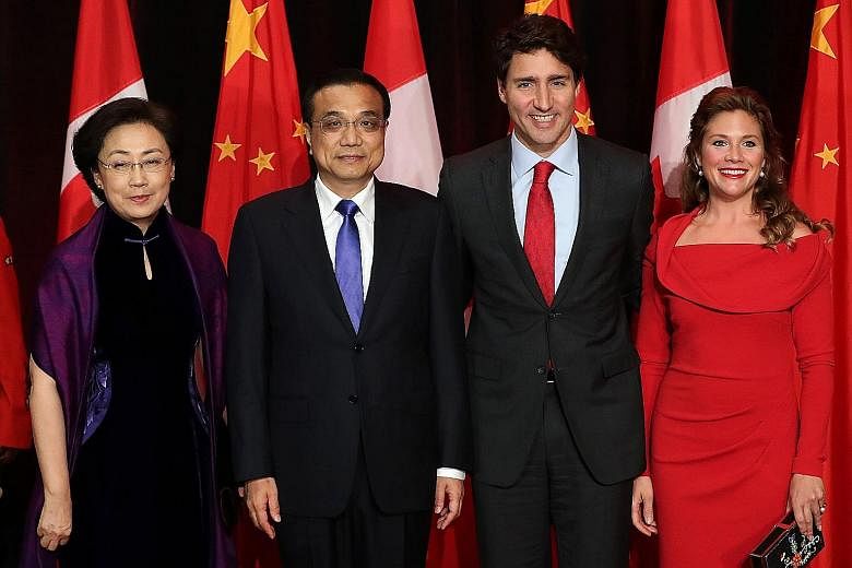 Chinese Premier Li Keqiang and Canadian Prime Minister Justin Trudeau with their wives before the state dinner in Quebec on Thursday. Mr Li's four-day visit, the first by a Chinese premier in 13 years, is a further step in moves to deepen ties betwee