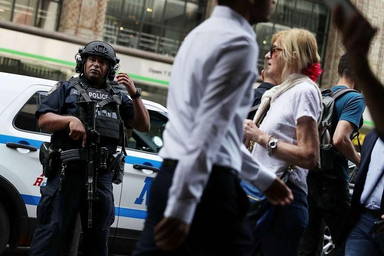 A New York City police officer on guard outside New York City's Grand Central Station this week after a bomb went off at the weekend in the busy neighbourhood of Chelsea. The incident is expected to have an impact on the presidential race in which nationa