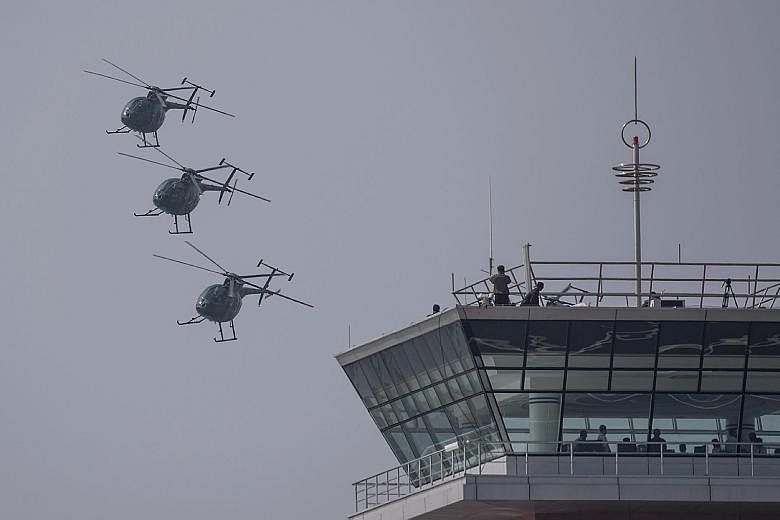 Hughes MD-500 helicopters in a fly-by during the Wonsan International Friendship Air Festival yesterday, North Korea's first public aviation show. Foreign media representatives and several hundred aviation enthusiasts from 20 countries were among the
