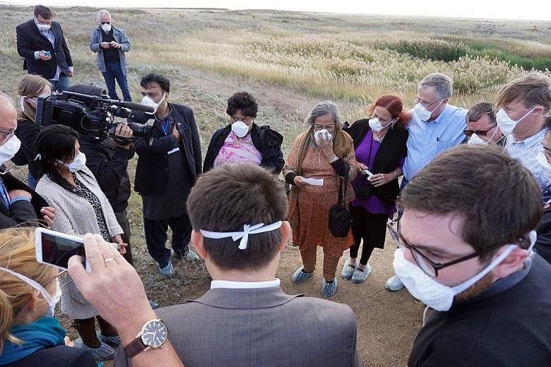 Left: Ms Ela Gandhi (in brown), granddaughter of Mahatma Gandhi, leading a prayer for world peace at the defunct Semipalatinsk nuclear test site. Right: The remnants of a watch tower, from which soldiers and scientists monitored nuclear explosions in