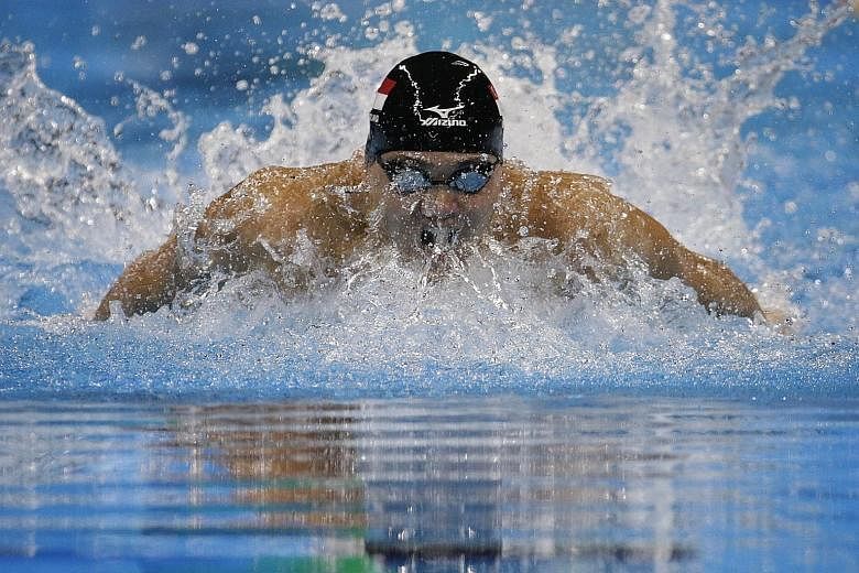 Joseph Schooling on his way to breaking the 100m butterfly Olympic mark in Rio in 50.39sec. While he is serious about targeting Michael Phelps' world record, he sees no need to ramp up the frequency of training just yet.