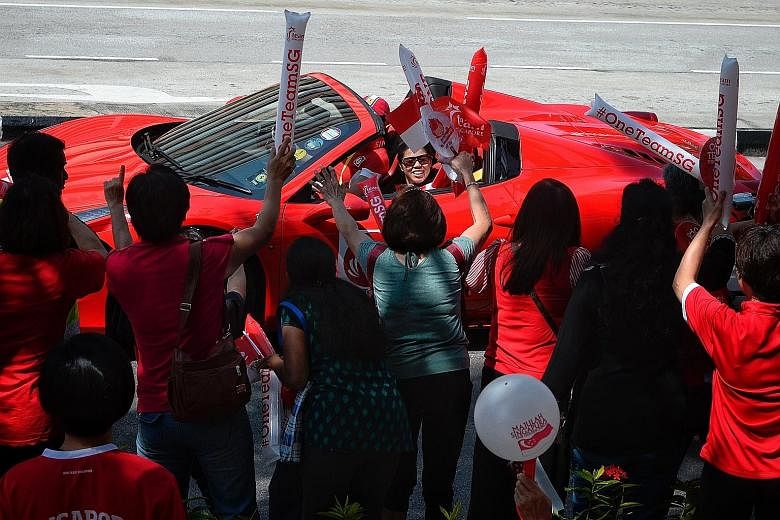 Rio Paralympics double swimming gold medallist Yip Pin Xiu waving to supporters outside Braddell Heights Community Club during the Singapore Paralympians' celebratory parade yesterday morning. The 13 Paralympians braved the hot sun as they travelled 