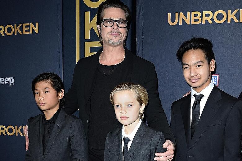 Actor Brad Pitt with his children (from far left) Pax, Shiloh and Maddox in 2014.