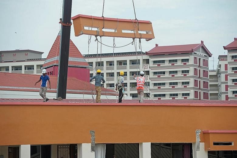 The dislodged sunshade being removed by a crane at Block 201E, Tampines Street 23 yesterday. BCA says it has told Tampines Town Council to engage a professional engineer to carry out a detailed investigation, and ordered checks on all other HDB block