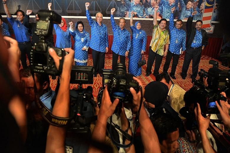 Mr Najib (centre) and his fellow BN members celebrating their election victory on May 6, 2013. The next general election is not due until August 2018, but rumours of early elections persist.