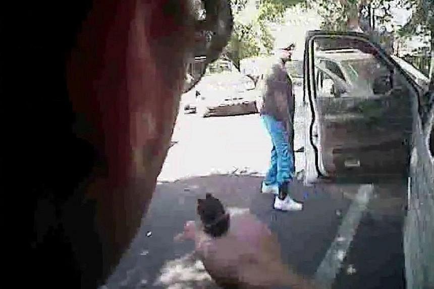 The body and dashboard camera videos released by the authorities on Saturday appear to show Mr Scott getting out of a white sport utility vehicle and backing away with his hands by his sides. No gun can be seen on Mr Scott in the videos, corroboratin