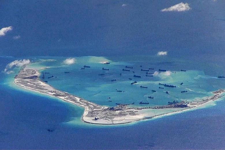 A photo provided by the US military showing what are described as Chinese dredging vessels in the waters around Mischief Reef in the disputed Spratly Islands.