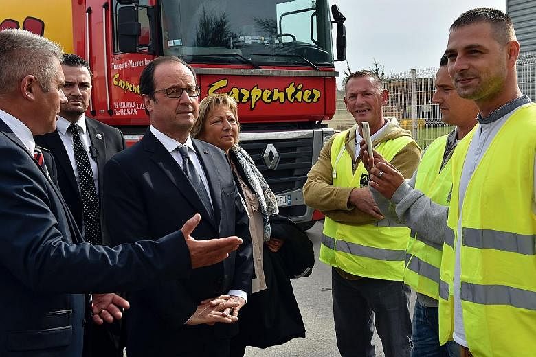 President Hollande (centre) visiting the French port of Calais, on the outskirts of which lie the sprawling "Jungle" camp. The camp, inhabited by thousands desperate to reach Britain, is a symbol of Europe's failure to resolve the migration crisis.