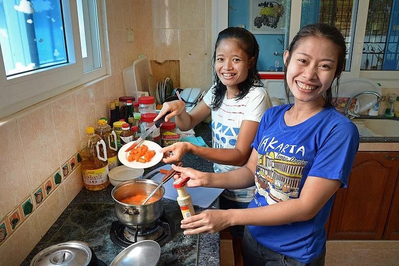 Indonesians Wiwik Mariyati, 34, and Carsih Carman Taja (far right), 29, work here as domestic helpers. The number of helpers like them as well as dependants on long-term visit passes, grew over the past year, contributing to the growth in non-residen