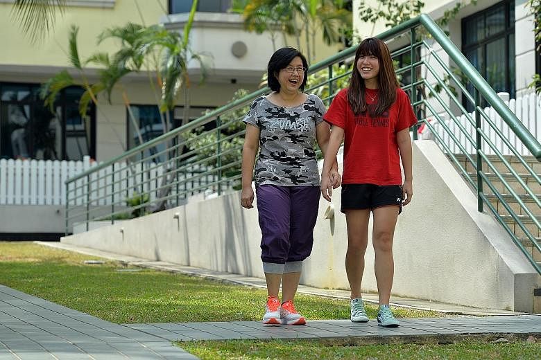 Breast cancer survivor Lim Loo See, 55, with her daughter Charmian Yeo, a 26-year-old student.