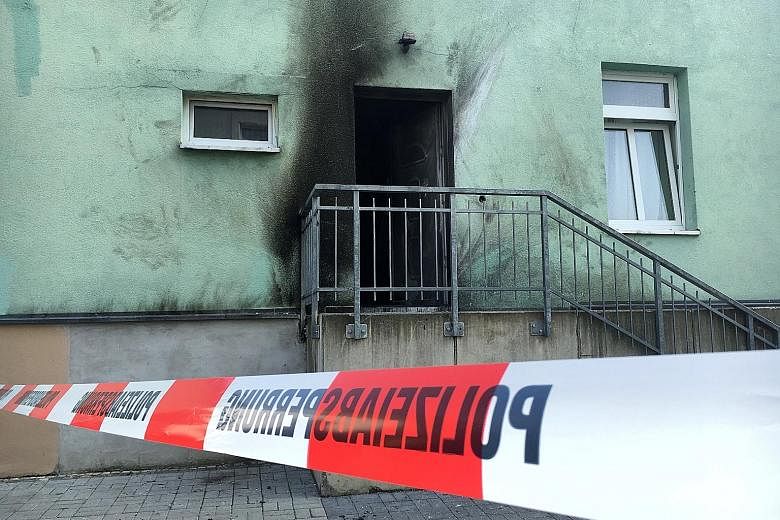 The entrance of a mosque (above) in Dresden was damaged by an improvised bomb on Monday. Another home-made device went off at an international conference centre. Police said they suspected a xenophobic and nationalist motive behind the explosions in 