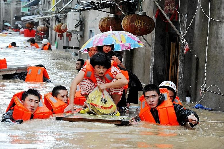 Rescuers evacuating residents in Ningde in eastern China's Fujian province yesterday. Typhoon Megi hit China with winds of around 120kmh.
