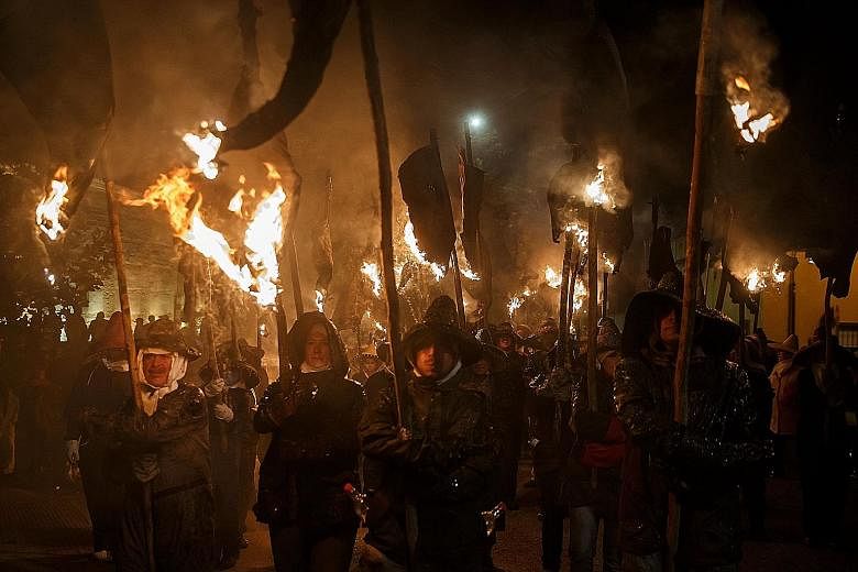 Locals using hanging wineskins in flames as torches as they took part in the Vitor's Civic Procession in Mayorga, Spain, on Tuesday. The procession marked the occasion on Sept 27, 1752 when the people of Mayorga emerged from their homes with torches 