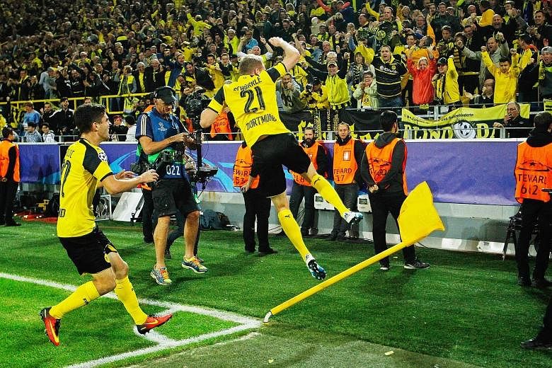 Andre Schurrle showing his joy after netting the late equaliser that helped Borussia Dortmund draw 2-2 with Real Madrid.