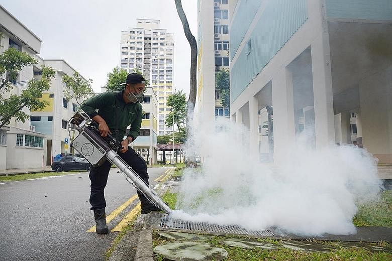 A contractor engaged by the town council fumigating the precinct of Bishan earlier this month.