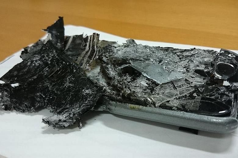 The charred remains of an unidentified cellphone which caught fire during a Qantas flight in June.