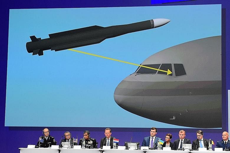 Left: Members of an international team presenting the preliminary results of a criminal investigation into the downing of Malaysia Airlines Flight MH17, in the Netherlands, yesterday. A reconstruction of the missile strike that is believed to have le