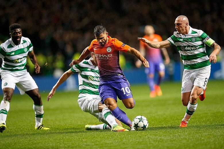 Celtic's Nir Bitton tackles Man City's Sergio Aguero as Kolo Toure (left) and Scott Brown give support in the Wednesday game.