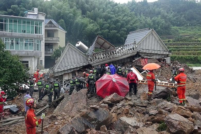Rescuers search for survivors among the rubble in Sucun village in Zhejiang province yesterday.